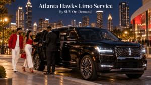 Atlanta Hawks limo service with a black Lincoln Navigator and chauffeur on a downtown Atlanta street at night with the city skyline lit up